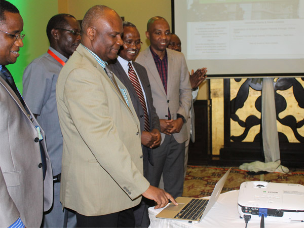 Tanzania Chief Medical Officer, Prof. Mohammed Bakari launches the TFDA online portal. He is flanked by the TFDA Director General, Hiiti B. Sillo.