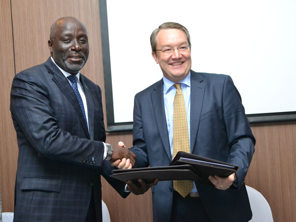 TMA Board Chair Ali Mufuruki exchanging MOU documents with the Finnish Deputy Head of Mission in Tanzania, Simo-Pekka Parviainen 